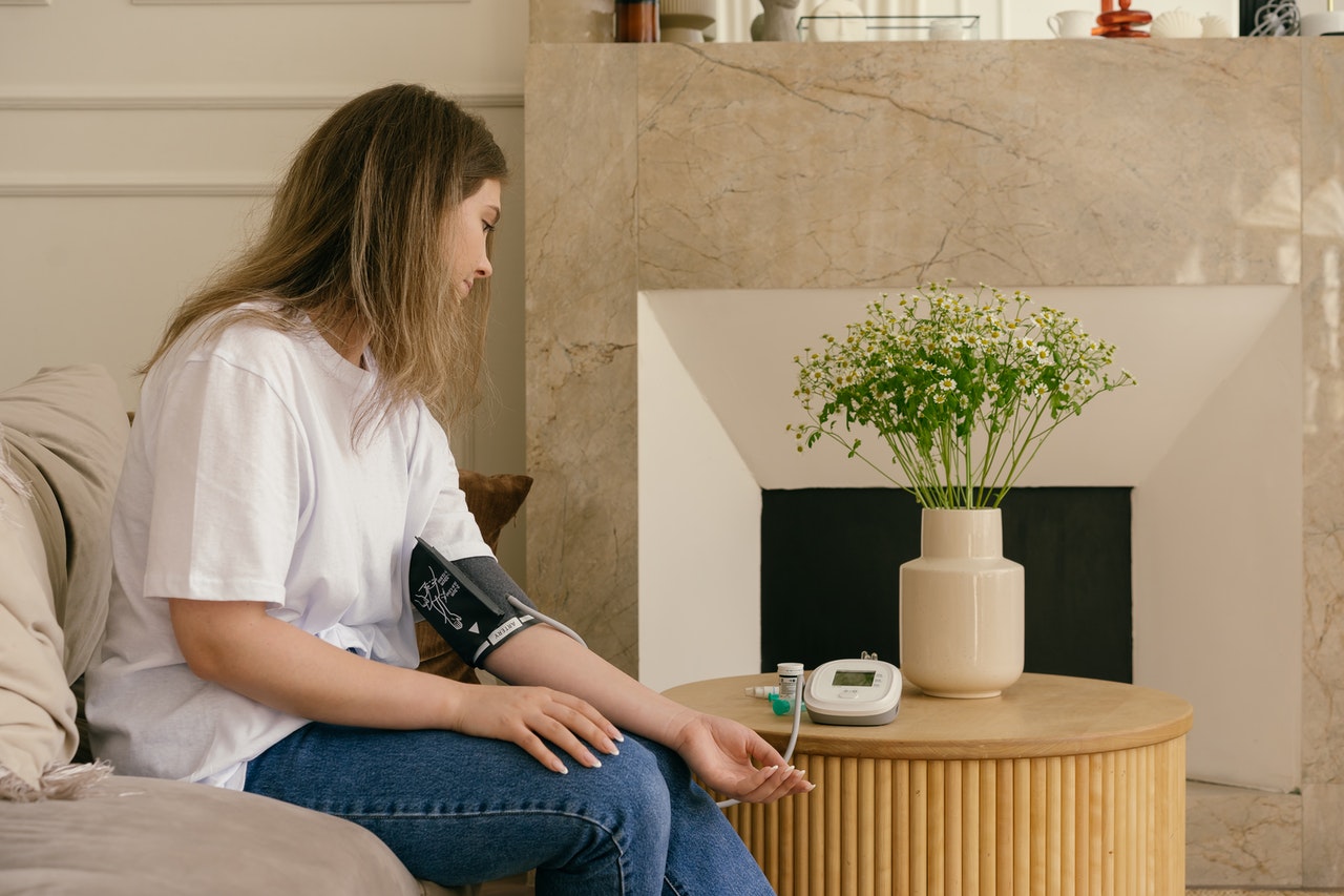 woman testing blood pressure